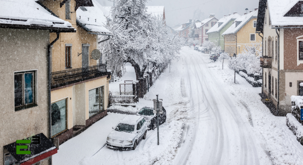 Extreme temperature weather, houses around, streets filled with snow.